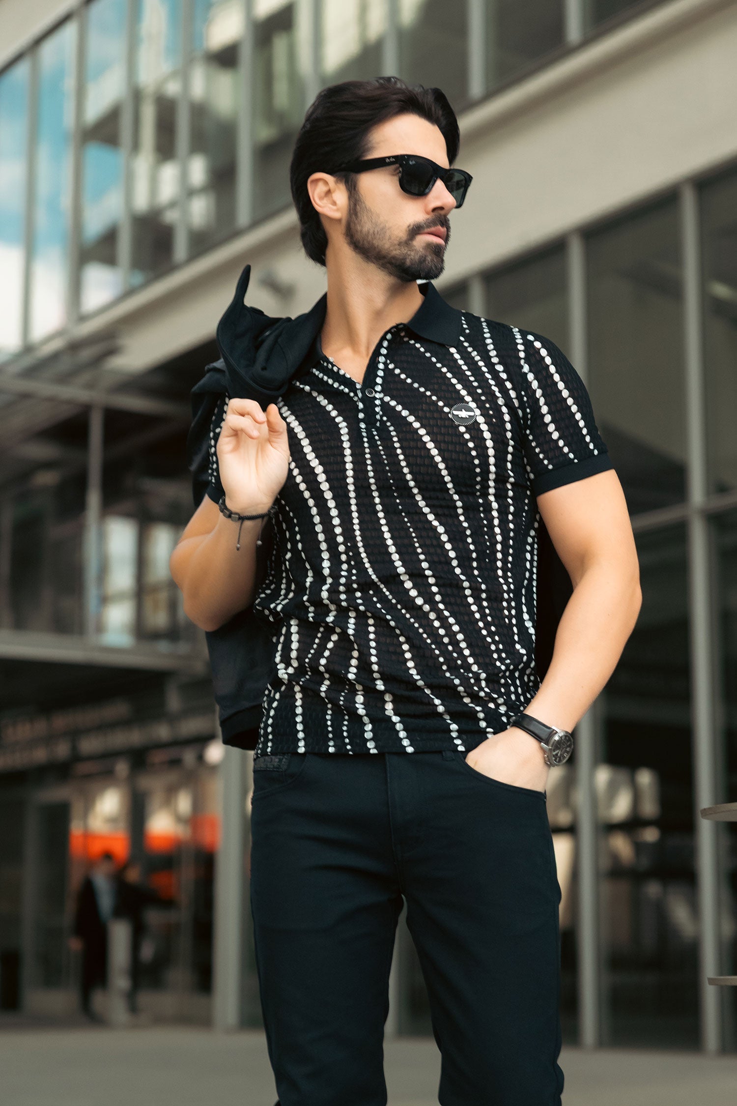 Premium black and white polka dot polo shirt styled for luxury travel - airport and professional style